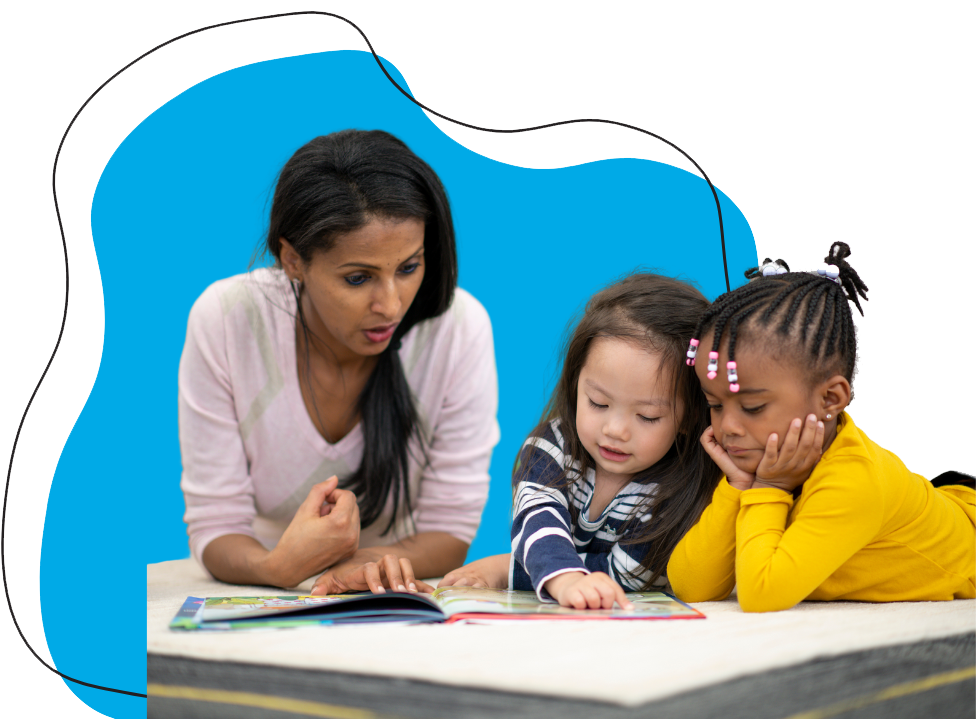 a woman and two young children reading a book